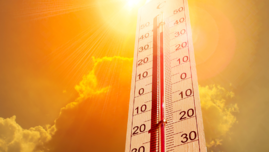 ilustracja termometr z zaznaczoną wysoką temperaturą oraz słońce